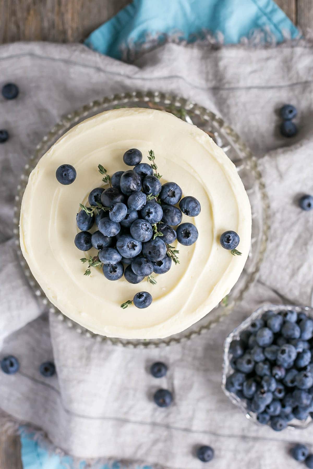 Blueberry Banana Cake! The delicious combination of bananas and blueberries gets paired with a tangy cream cheese frosting in this Blueberry Banana Cake recipe. | livforcake.com Overhear shot of this easy banana cake with fresh blueberries.