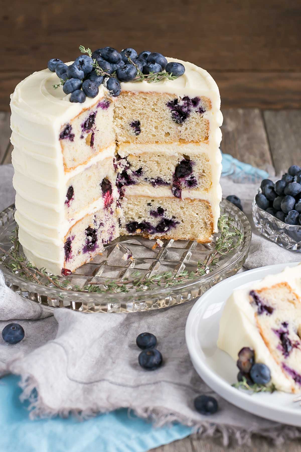 Blueberry Banana Cake! The delicious combination of bananas and blueberries gets paired with a tangy cream cheese frosting in this Blueberry Banana Cake recipe. | livforcake.com Cross section of this Blueberry Banana Cake.