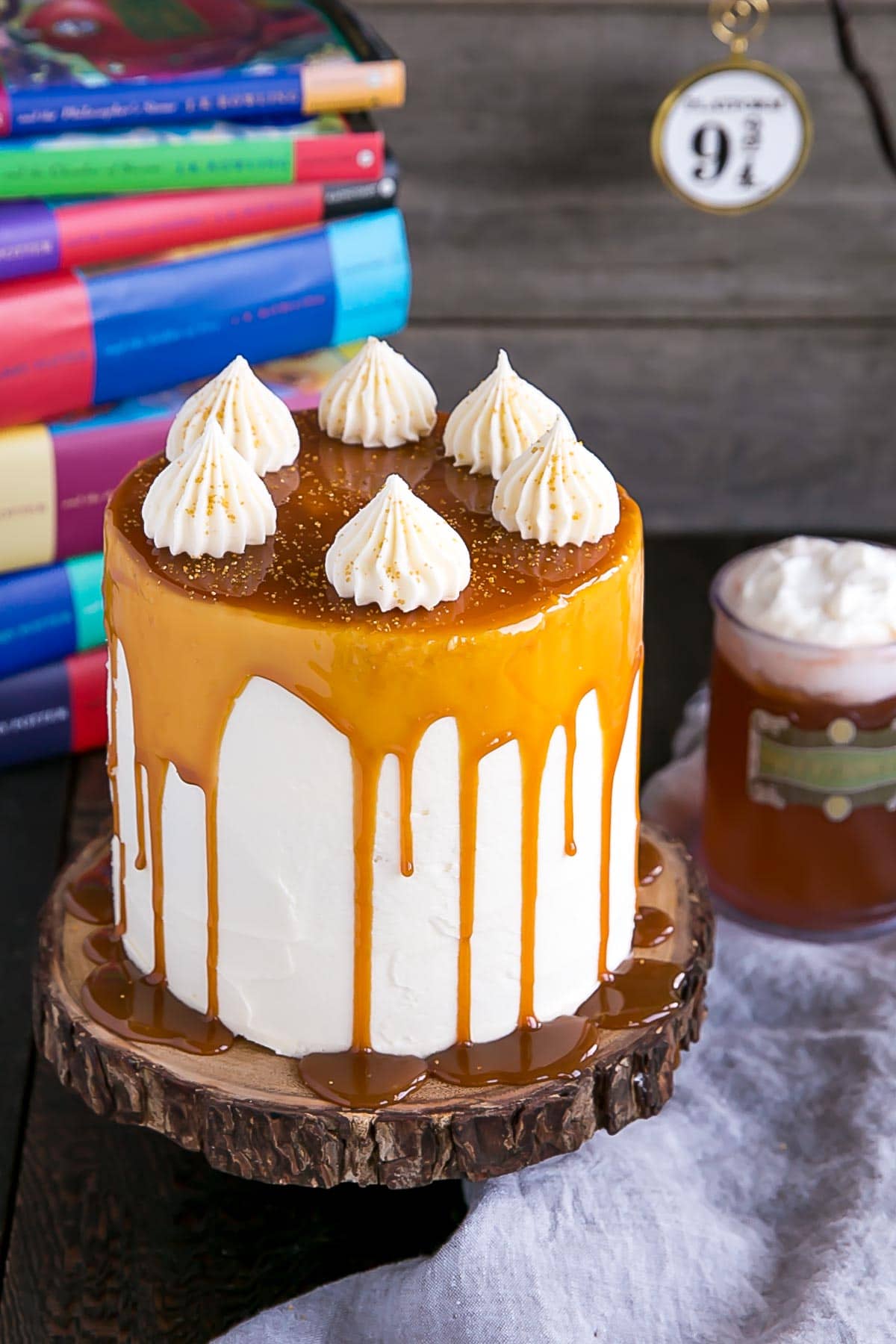 Harry Potter Cake! This Butterbeer cake combines butterscotch, cream soda, and marshmallow all in one spellbinding dessert. | livforcake.com Harry Potter Butterbeer Cake with a butterscotch drip.
