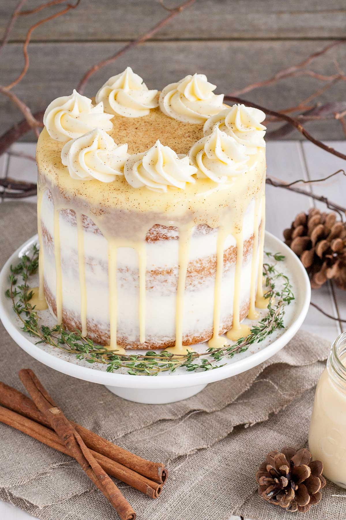 This Eggnog Cake with cream cheese frosting and white chocolate ganache is just the thing to warm you up this Holiday season! | livforcake.com Eggnog cake with rum simple syrup and cream cheese frosting.
