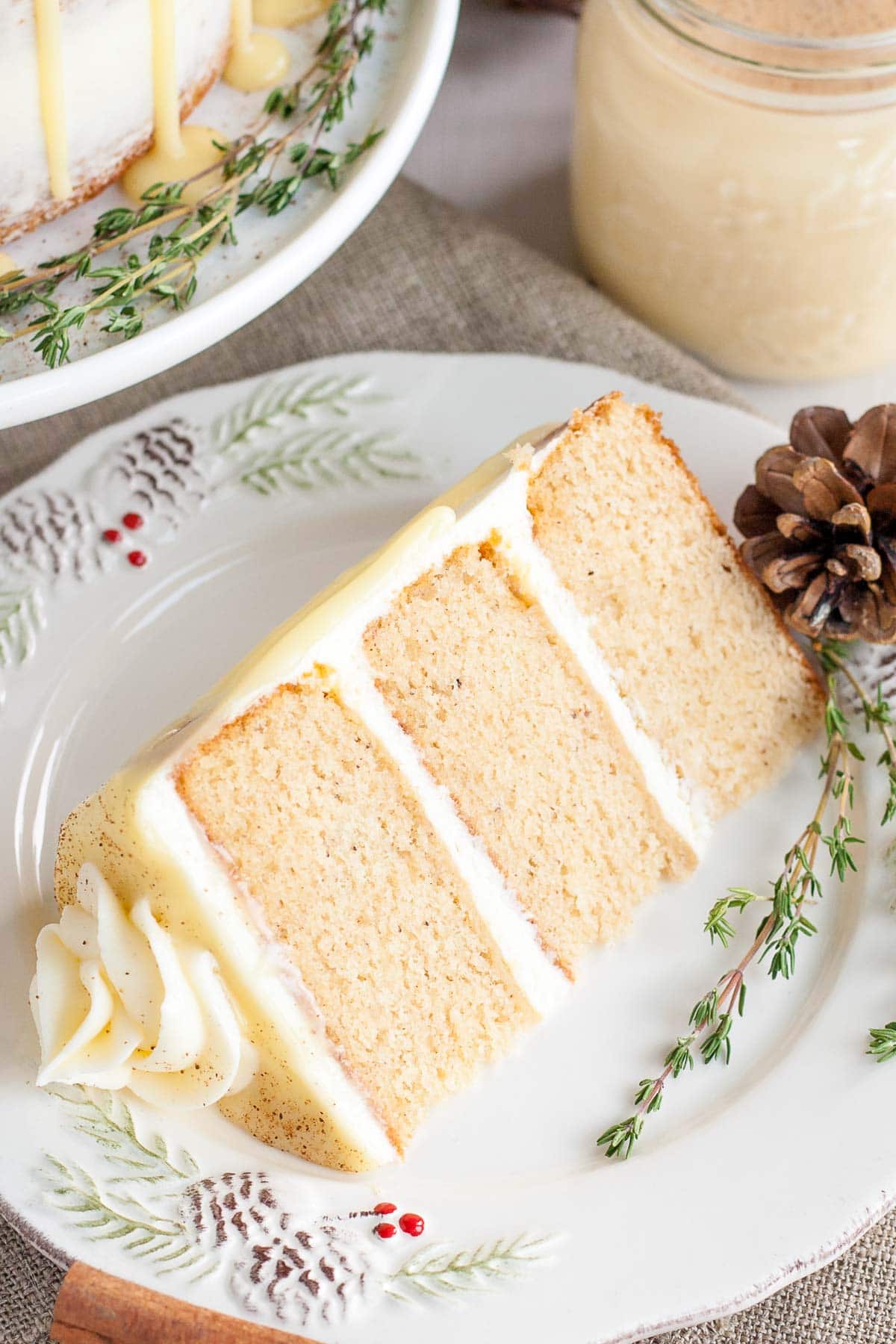 This Eggnog Cake with cream cheese frosting and white chocolate ganache is just the thing to warm you up this Holiday season! | livforcake.com Eggnog cake slice.
