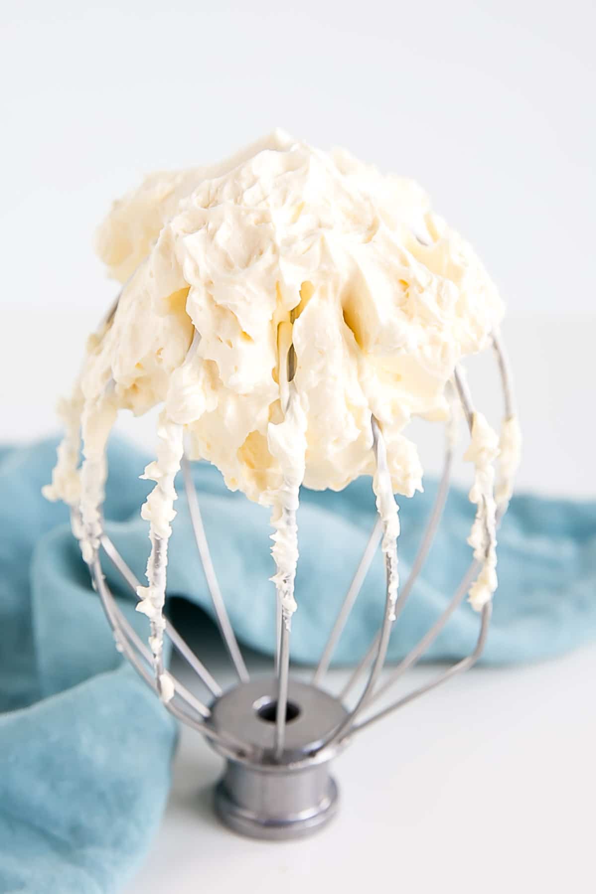 This custard-based German buttercream is made with just a few simple ingredients. Perfect for those who like a rich and silky frosting that isn't too sweet! | livforcake.com German buttercream on a whisk.