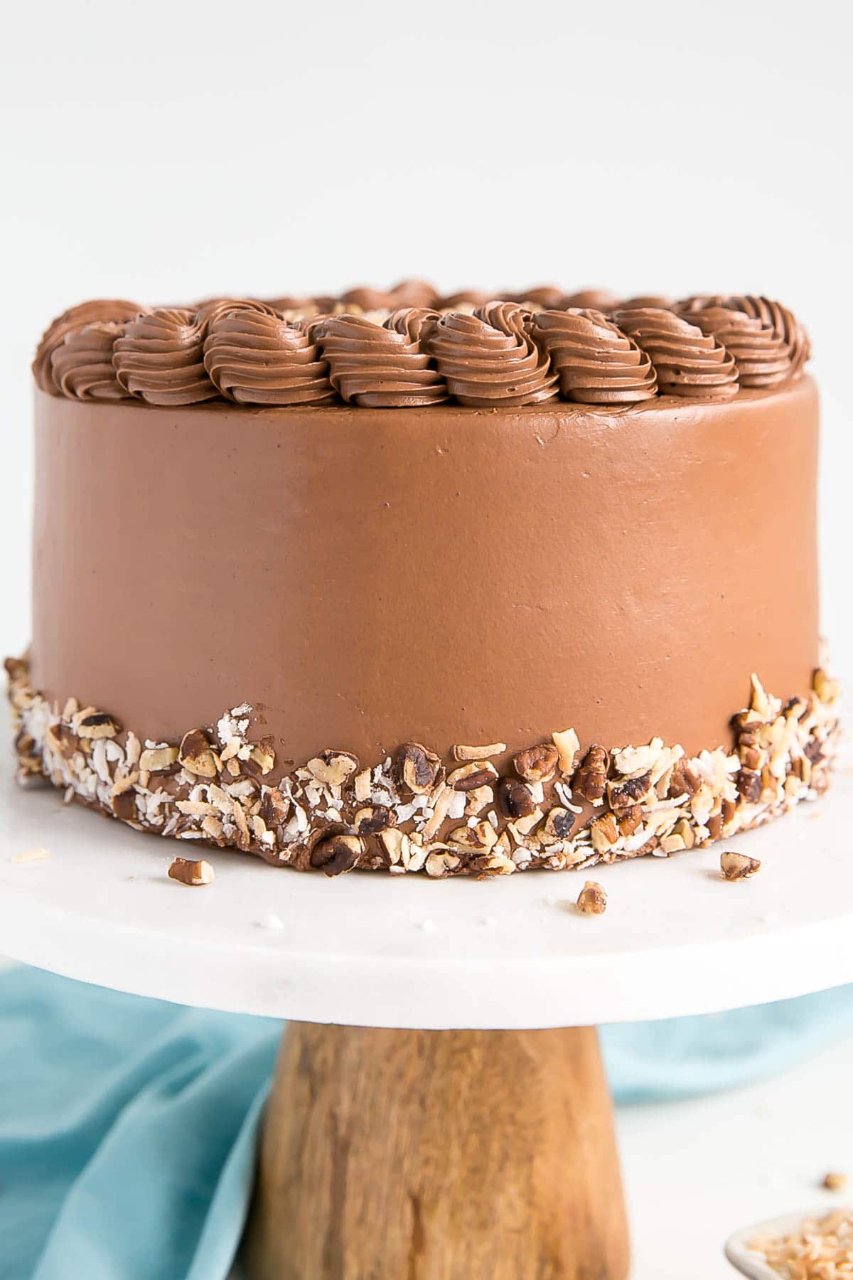 This Classic German Chocolate Cake combines rich chocolate cake layers with a sweet coconut pecan filling and a dreamy chocolate buttercream. | livforcake.com Close up of he front of the cake.