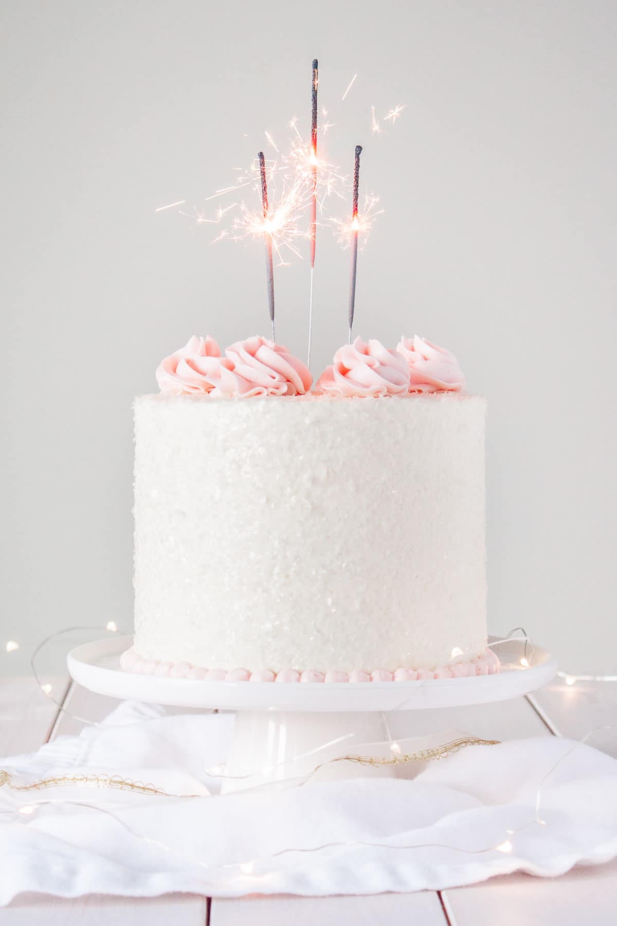 This Pink Champagne Cake is the perfect way to celebrate any occasion or holiday! A champagne infused cake with a classic vanilla buttercream. | livforcake.com A champagne infused cake with a classic vanilla buttercream.