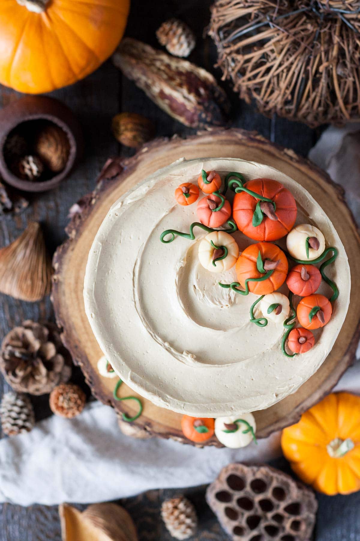 This Pumpkin Spice Latte Cake is your favorite Fall beverage in cake form! Pumpkin spice cake with an espresso buttercream. | livforcake.com Overhead shot of Pumpkin Spice Latte Cake and fondant pumpkins