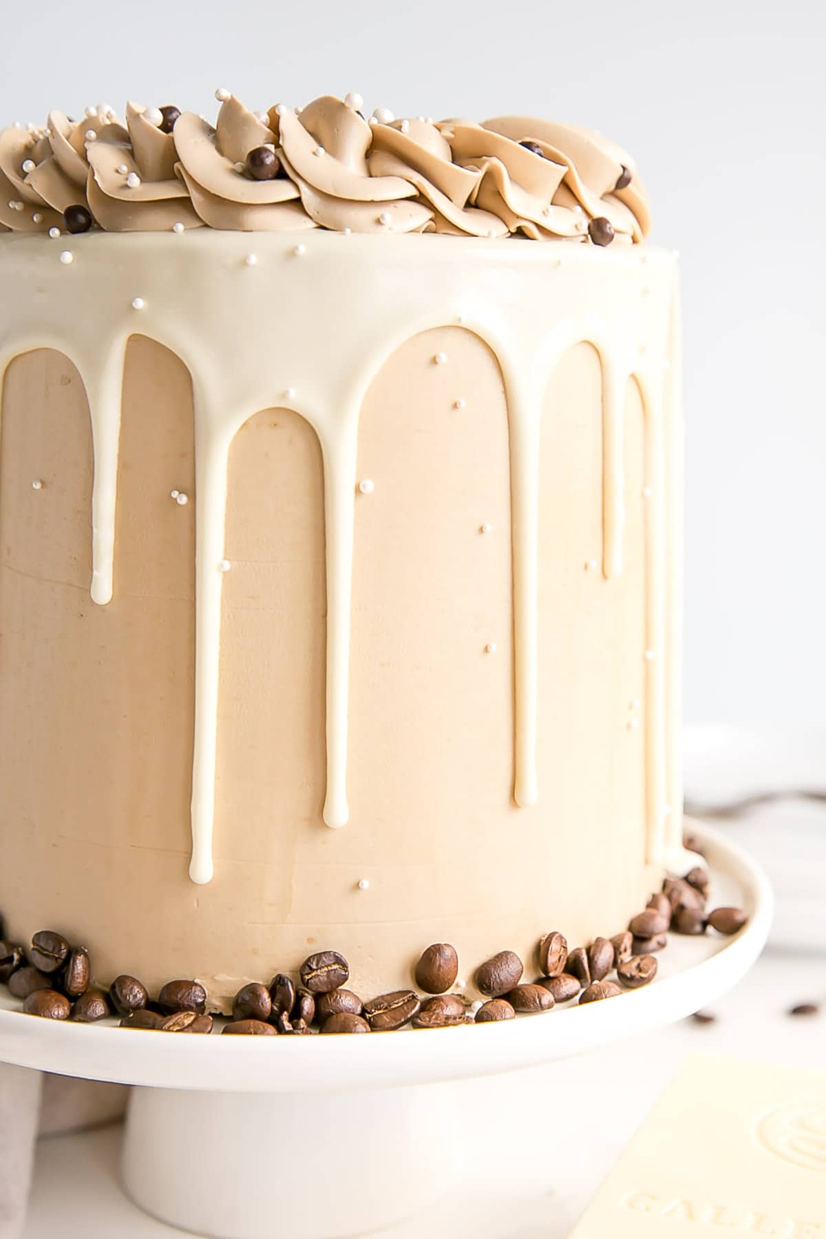Close up of the side of the cake showing the frosting and the white chocolate ganache drip.